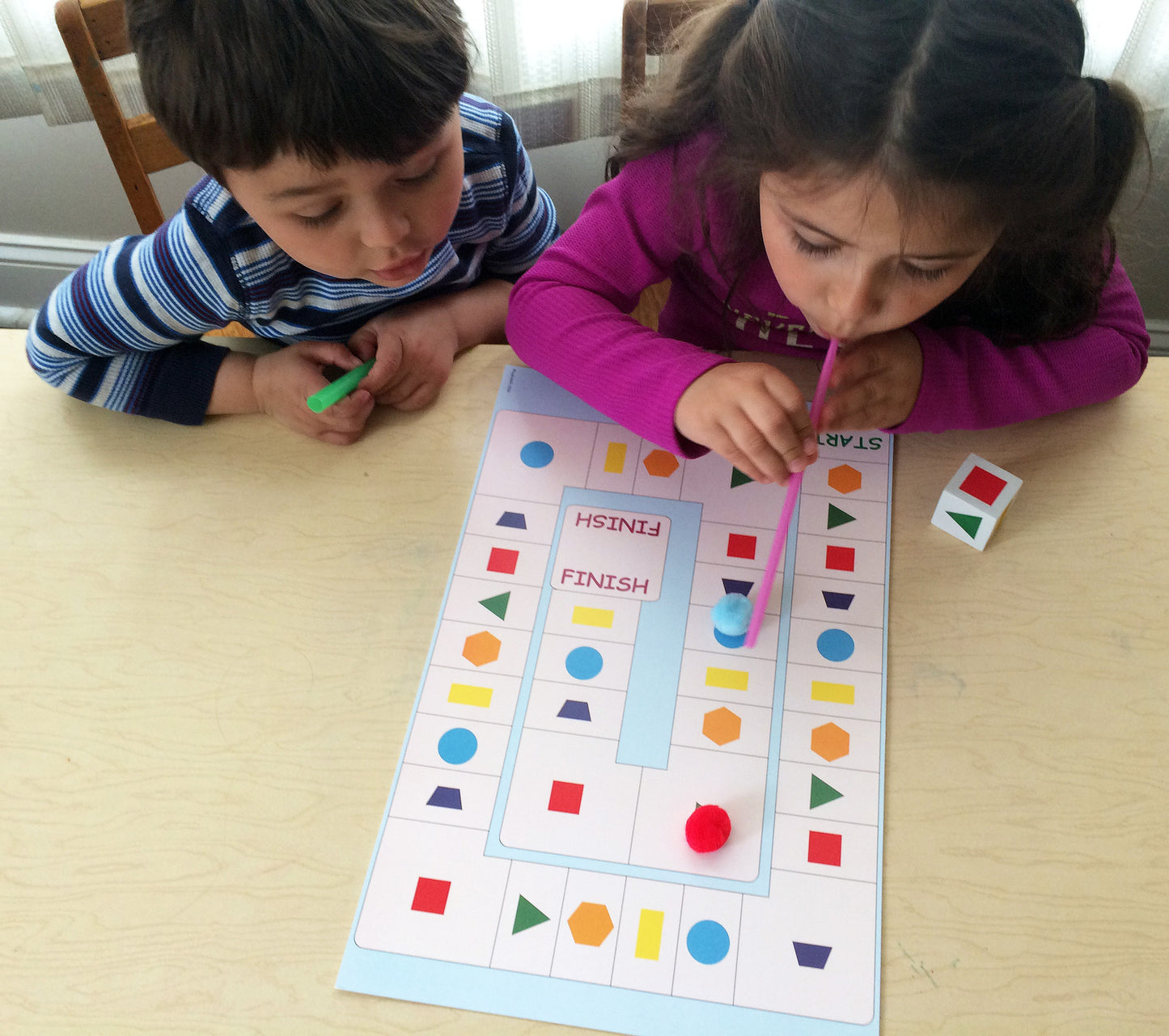 Blowing Along the Shape Path, math game that uses wind energy, to go along with May's Ivy Kids kit featuring the book The Wind Blew by Pat Hutchins. 